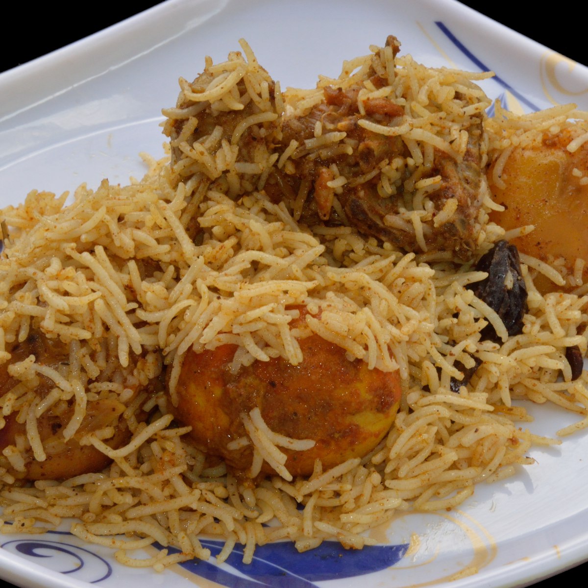 Golden basmati chicken biryani with boiled egg