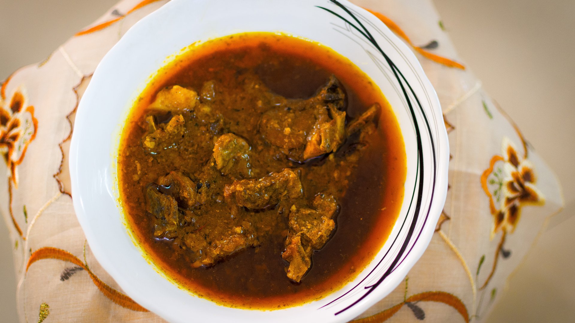 A rich, aromatic Indian curry dish served with rice and naan
